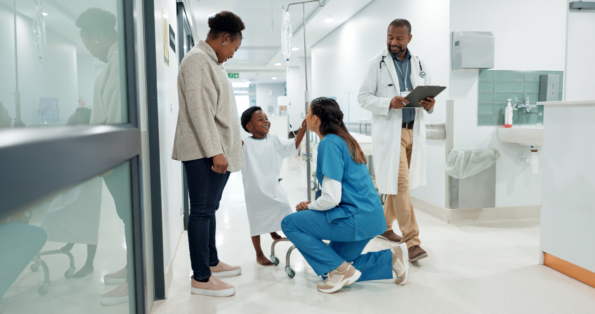 Nurses talking with a family in a hospital hallway